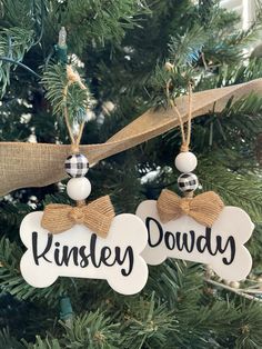two christmas ornaments hanging from a tree with the words kinsley dowy on them
