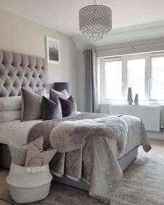 an instagram photo of a bedroom with grey bedding