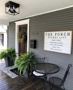 the porch is decorated with potted plants