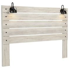 a white wooden headboard with two lights on each side and one light at the top