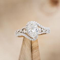 a diamond ring on top of a piece of wood