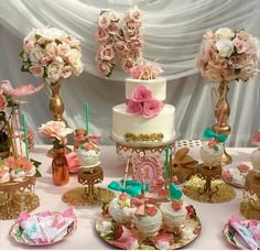 a table topped with lots of different types of cakes