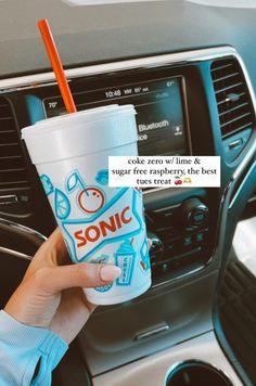 a person holding up a cup in their hand with the words sonic printed on it