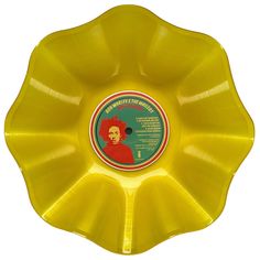 a yellow frisbee with an image of a man on it's side