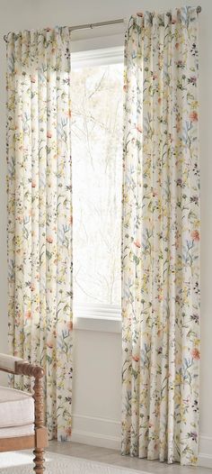 the curtains in this room are made from floral fabric