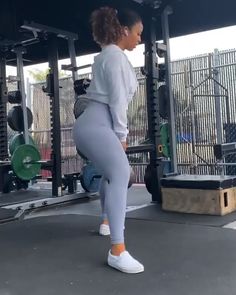 a woman doing squats in front of a gym machine with the caption if you want more fitness tips, visit our website