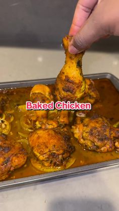 someone is dipping some food into a pan with sauce on it and the words baked chicken above them