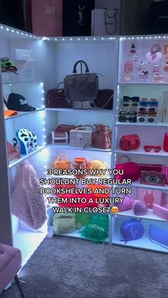 a display case filled with lots of handbags and purses on shelves next to a pink chair