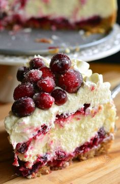 a piece of cheesecake with cranberries on top