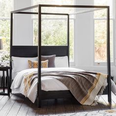 Made of mango wood, this black boho style four poster bed features carved headboard detailing. #bohobedroom #bohofourposterbed Bedroom, Bedroom Décor, Boho Bedding, Black Bedding, Luxurious Bedrooms