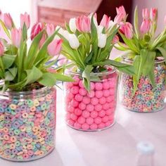 three vases filled with candy and flowers