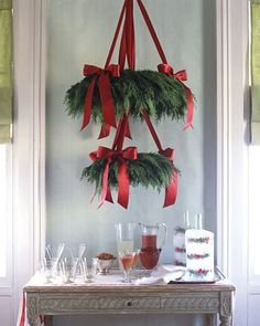 christmas decorations hang from the ceiling in front of a table with drinks and desserts on it