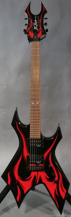 a black and red guitar with flames on it