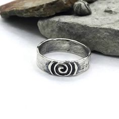 Description: SImple ring with softly textured band, center piece is a life spiral with a raised design. Available to ship Size: 4-14 I can size in whole, half or quarter sizes because we don't all fit perfectly in the whole sizes. Depending on the ring design, the design can change depending on the size. Made to order pieces - design will vary slightly from the photo, as each ring is handcrafted just for you! Specifications: Materials: Sterling silver Approximately width 6.25 mm Jewelry by Caria Bijoux, Metal Jewellery, Piercing, Silver Ring, Band Rings, Silver Rings, Sterling Silver Rings, Metal Rings, Unique Silver Rings