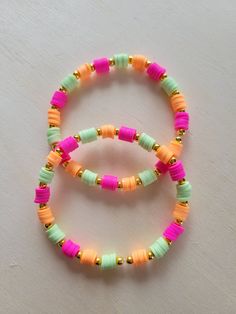 Brightly Colored Polymer Clay Beads with Small Gold Circular Spacers In Between Each Colored Sections