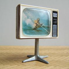 an old tv with a boat on the screen
