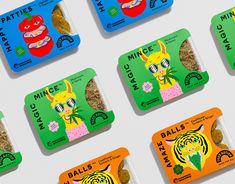 six packets of cat treats are displayed on a white surface with green and orange labels
