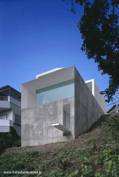 the house is made out of concrete and has glass windows