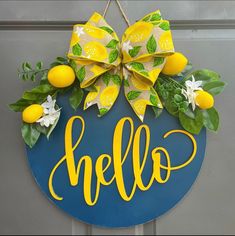 a blue and yellow door hanger that says hello with lemons and flowers on it
