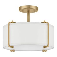 a semi flush light fixture with white shades on the bottom and gold trimmings
