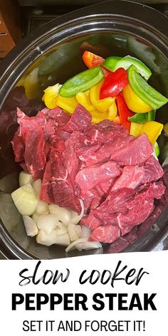 slow cooker pepper steak served in a pot with onions, peppers and celery