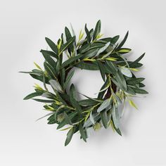 a wreath made out of green leaves on a white background
