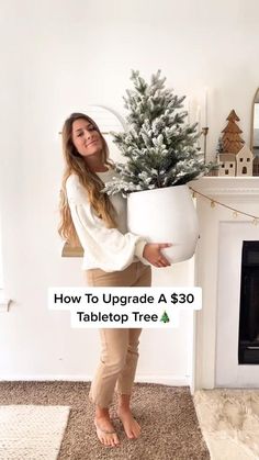 a woman holding a potted christmas tree in front of a fireplace with the text how to upgrade a $ 30 tabletop tree
