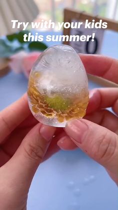 someone is holding up a glass with ice and water in it that says try with your kids this summer