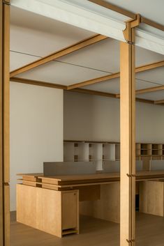 an empty office space with wooden desks and shelves