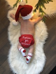 a baby is wearing a santa hat and diaper