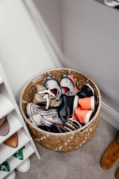 a basket filled with shoes sitting on the floor