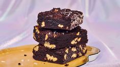 three brownies stacked on top of each other with peanut butter and chocolate chip toppings