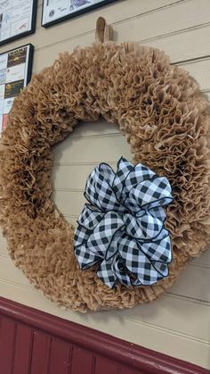 a wreath with a bow hanging on the wall