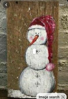 an image of a snowman with a red hat