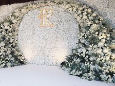 a white and gold wedding arch with flowers on it