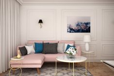 a living room with a pink couch and coffee table in front of a painting on the wall