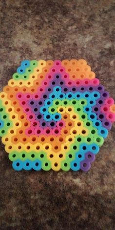 a multicolored object on the ground with holes in it