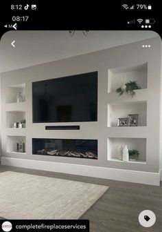a large flat screen tv mounted to the side of a wall in a living room