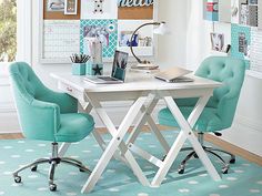 a white table with two blue chairs and pictures on the wall behind it that says hello