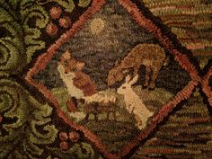 a close up of a rug with animals on it