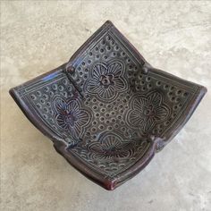 a decorative bowl sitting on top of a table