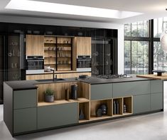 a modern kitchen with an island and shelves in the center, along with large windows