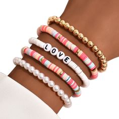 three different bracelets with the word love written on them and beads in gold, white, pink, and green