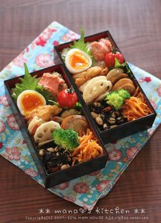 two bento boxes filled with different types of food