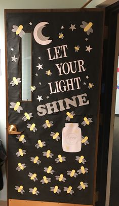 a door decorated with stars, moon and the words let your light shine