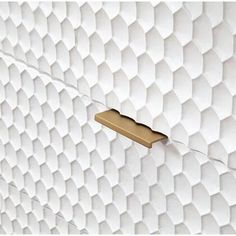 a close up of a white wall with gold handles