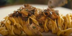 pasta with mushrooms and sauce on a white plate