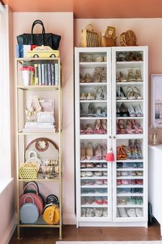 a white bookcase filled with lots of shoes next to a wall mounted shelf full of purses