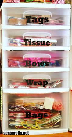 plastic storage bins with labels on them in a closet filled with crafting supplies