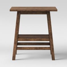 a small wooden table with one shelf on the bottom and two shelves below it, all in dark wood